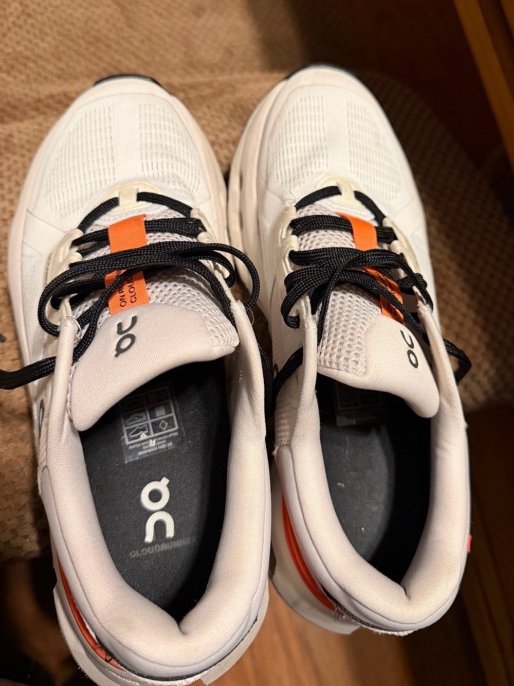 On Running woman’s White Athletic Sneakers with Orange Accent